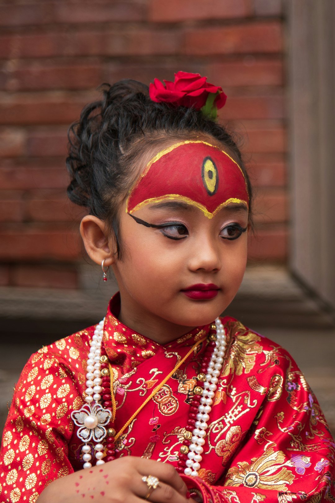 a-young-girl-wearing-a-red-and-gold-costume-8qydpngpkee