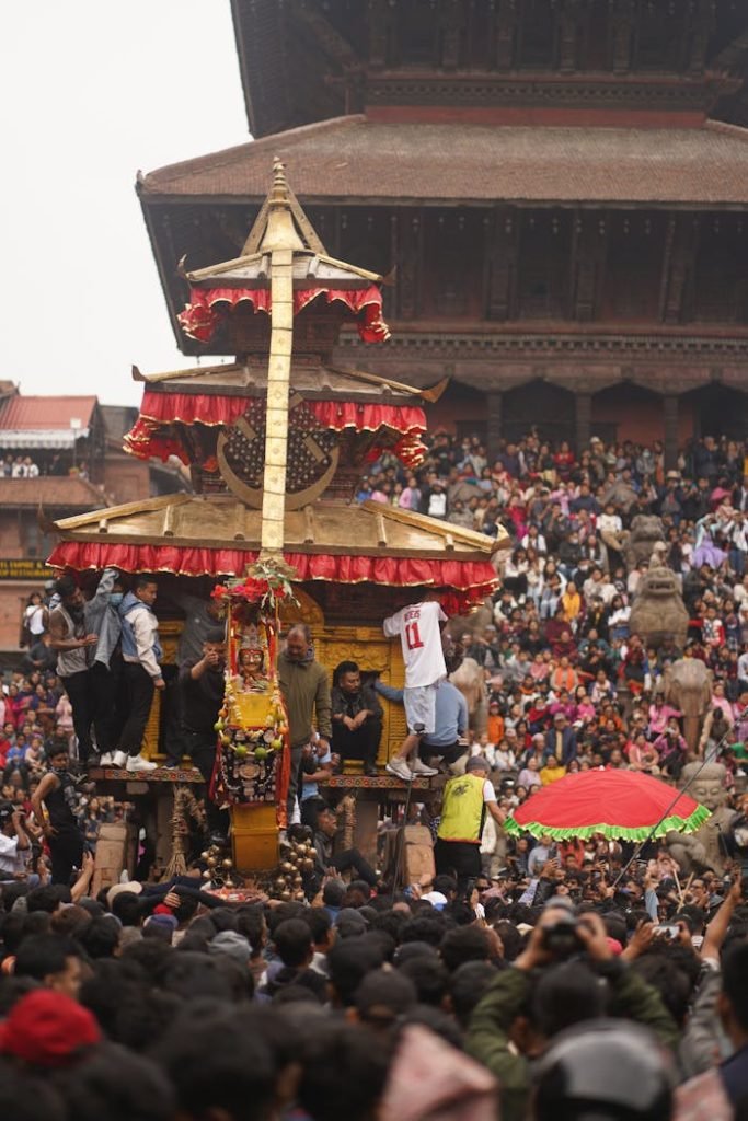 Crowds gather for the colorful Biska Jatra festival procession in historic Bhaktapur, Nepal.